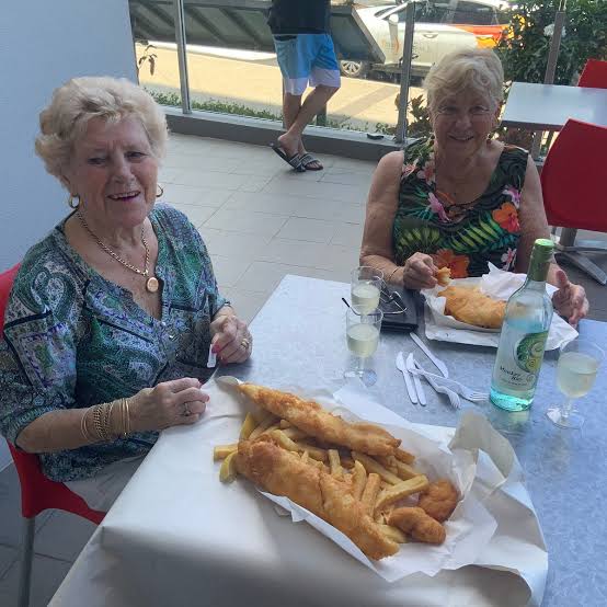 Happy diners enjoying fish and chips
